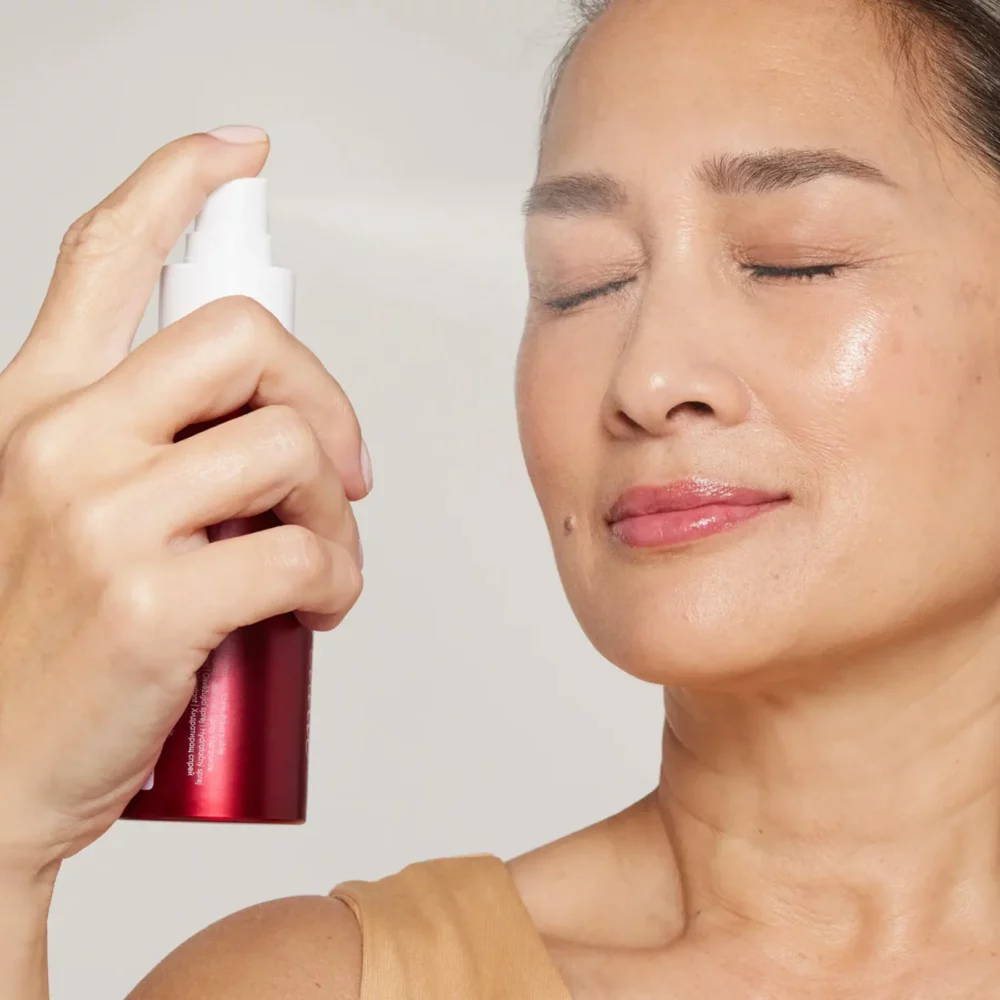 Eine schöne Frau sprüht sich das wohltuende Pommisst Hydration Spray ins Gesicht - ein Feuchtigkeitsspray von janeiredale Mineral Makeup - bei Claresco Cosmetic